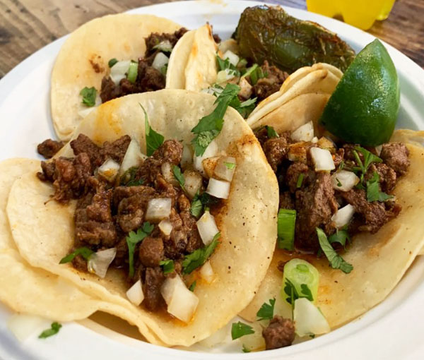 Street tacos with meat, onions, cilantro, lime and roasted poblano pepper